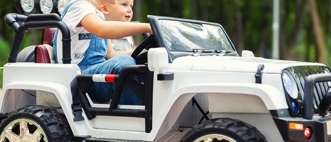 Children riding an electric car outdoors